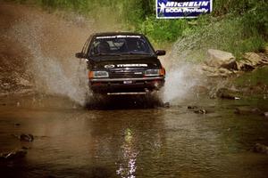 Tom Ottey / Pam McGarvey Mazda 323GTX at the finish of SS1, Stony Crossing.