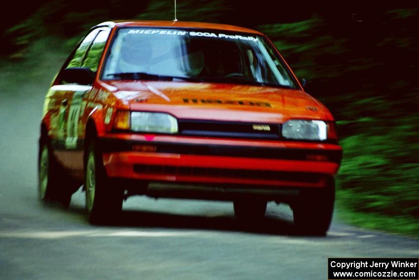 Gail Truess / Pattie Hughes Mazda 323GTX at speed on the practice stage.