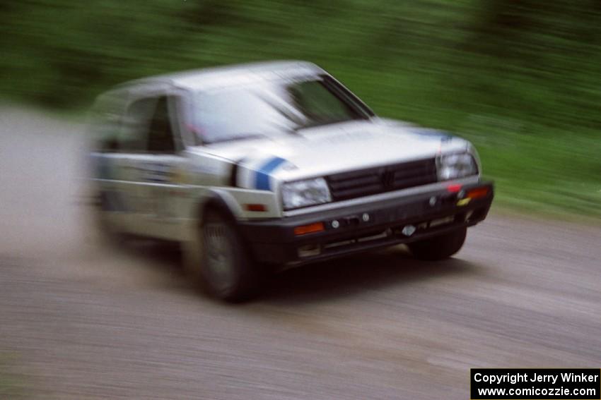 Eric Burmeister / Mark Buskirk VW GTI at speed on the practice stage.