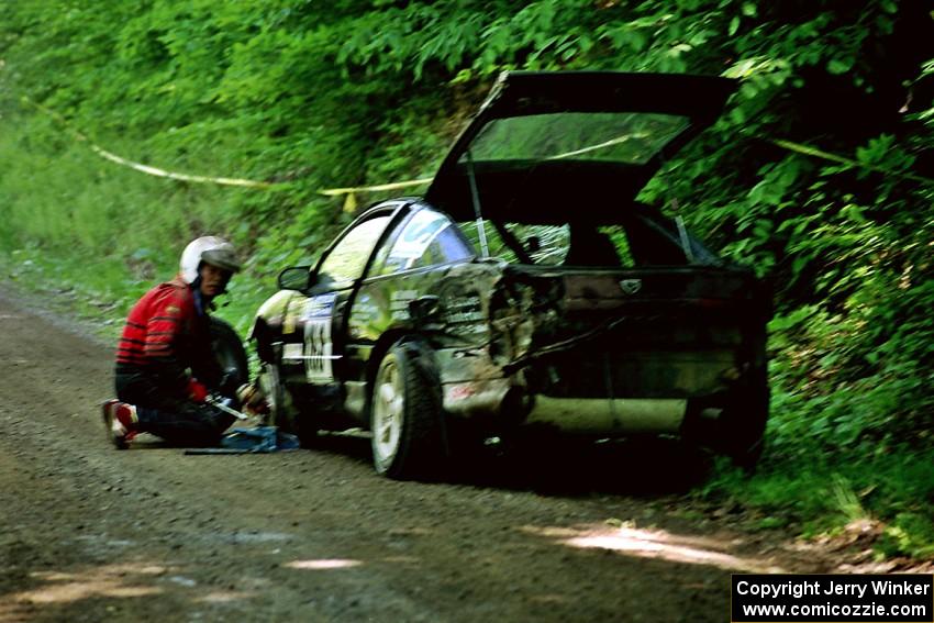 Celsus Donnelly / Kevin Mullan Eagle Talon changes a flat just past the FTC of SS1, Stony Crossing.