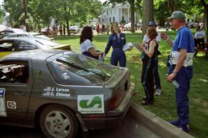 Diane Sargent is either overjoyed or is breaking out into song next to the Jens Larsen / Claire Chizma Mazda RX-7.