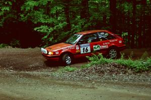 Gail Truess / Pattie Hughes Mazda 323GTX slides into a hairpin on SS5, Thompson Point I.