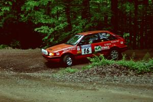 Gail Truess / Pattie Hughes Mazda 323GTX slides into a hairpin on SS5, Thompson Point I.