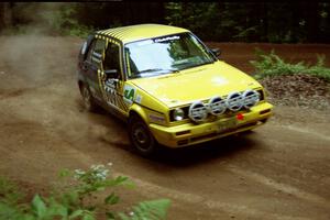 Konstantin Roumiantsev / Elena Roumiantsev VW GTI powers out of a hairpin on SS5, Thompson Point I.