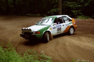 Donal Mulleady / Barry Smyth Mazda 323GTX powers out of a hairpin on SS5, Thompson Point I.