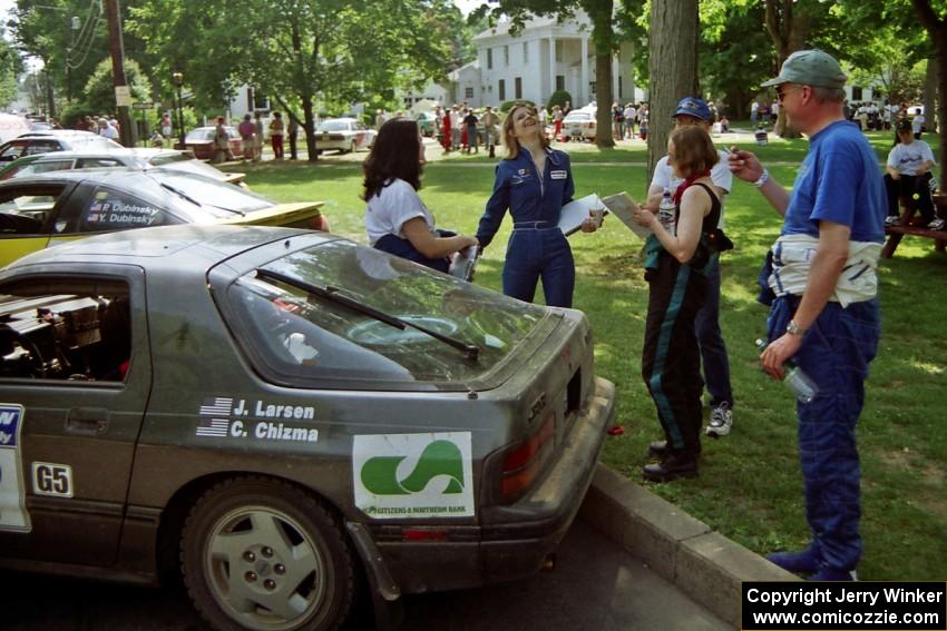 Diane Sargent is either overjoyed or is breaking out into song next to the Jens Larsen / Claire Chizma Mazda RX-7.