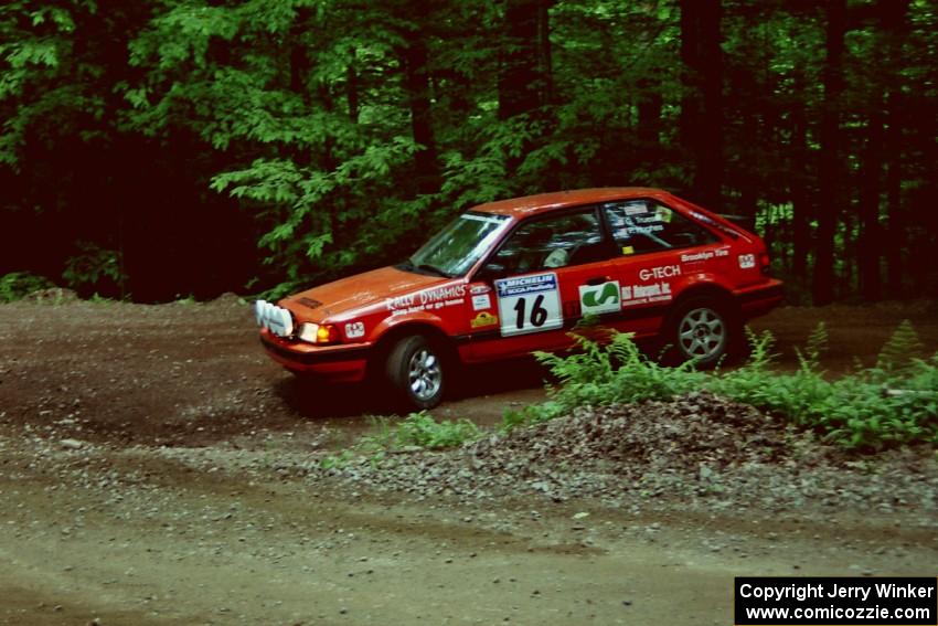 Gail Truess / Pattie Hughes Mazda 323GTX slides into a hairpin on SS5, Thompson Point I.