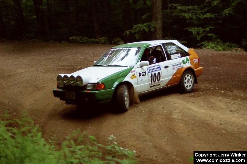 Donal Mulleady / Barry Smyth Mazda 323GTX powers out of a hairpin on SS5, Thompson Point I.