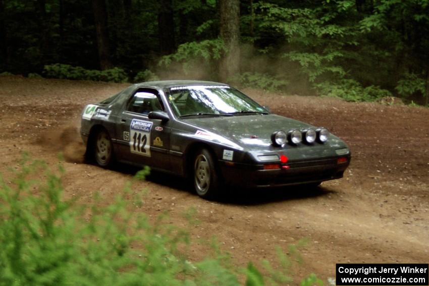 Jens Larsen / Claire Chizma Mazda RX-7 powers out of a hairpin on SS5, Thompson Point I.