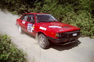 Jon Kemp / Rod Hendricksen Audi 4000 Quattro at speed over a bridge on SS5, Magalloway North.