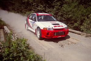 Garen Shrader / Doc Schrader Mitsubishi Lancer Evo IV at speed over a bridge on SS5, Magalloway North.