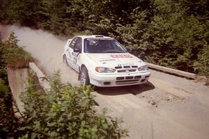 Dean Panton / Michael Fennell Hyundai Elantra at speed over a bridge on SS5, Magalloway North.