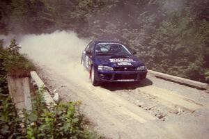 Bill Driegert / Claire Chizma Subaru WRX at speed over a bridge on SS5, Magalloway North.