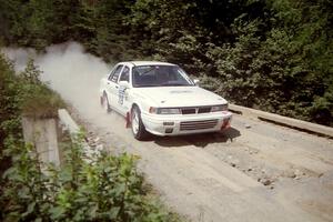 Seamus Burke / Mark Williams Mitsubishi Galant VR-4 at speed over a bridge on SS5, Magalloway North.