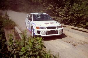 Malachy Crawford / Finian Hannigan Mitsubishi Lancer Evo V at speed over a bridge on SS5, Magalloway North.