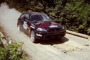 Bryan Hourt / Pete Cardimen Honda Civic at speed over a bridge on SS5, Magalloway North.