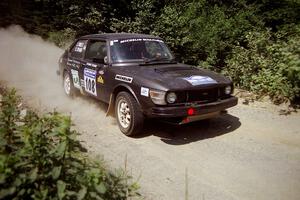 Jerry Sweet / Stuart Spark SAAB 99EMS at speed over a bridge on SS5, Magalloway North.