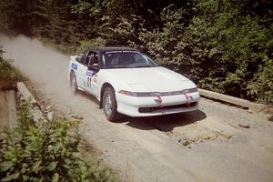 Chris Czyzio / Eric Carlson Mitsubishi Eclipse GSX at speed over a bridge on SS5, Magalloway North.