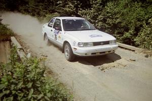 Ted Mendham / Lise Mendham Nissan Sentra SE-R at speed over a bridge on SS5, Magalloway North.