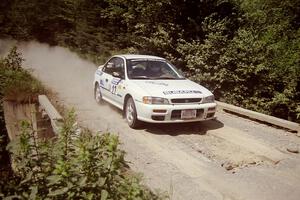 Greg Healey / John MacLeod Subaru Impreza at speed over a bridge on SS5, Magalloway North.