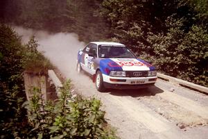 Alex Erisoty / Ben Greisler Audi 90 Quattro at speed over a bridge on SS5, Magalloway North.