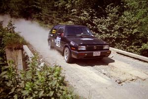 Tom Lawless / Brendan Lawless VW GTI at speed over a bridge on SS5, Magalloway North.