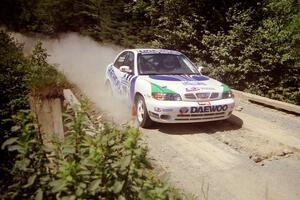 Peter Malaszuk / Darek Szerejko Daewoo Nubira at speed over a bridge on SS5, Magalloway North.