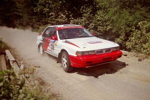 Arthur Wojcik / Chuck Cox Mitsubishi Galant VR-4 at speed over a bridge on SS5, Magalloway North.