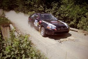 Nick Robinson / Carl Lindquist Honda Civic at speed over a bridge on SS5, Magalloway North.