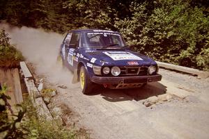 Mike White / Mike Ronan SAAB 99GLI at speed over a bridge on SS5, Magalloway North.