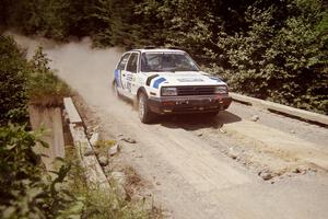 Eric Burmeister / Mark Buskirk VW GTI at speed over a bridge on SS5, Magalloway North.