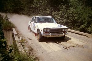 Walt Kammer / Jackie Adams Datsun 510 at speed over a bridge on SS5, Magalloway North.