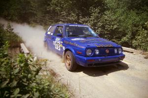 Patrick Lilly / Mark McAllister VW GTI at speed over a bridge on SS5, Magalloway North.