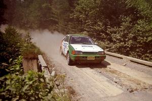 Donal Mulleady / John Reilly Mazda 323GTX at speed over a bridge on SS5, Magalloway North.