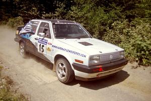 Brad Hawkins / Adrian Wintle VW Jetta at speed over a bridge on SS5, Magalloway North.