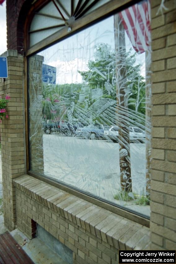 Etched glass on one of the diners depicting a scene of milling in Rumford, ME.