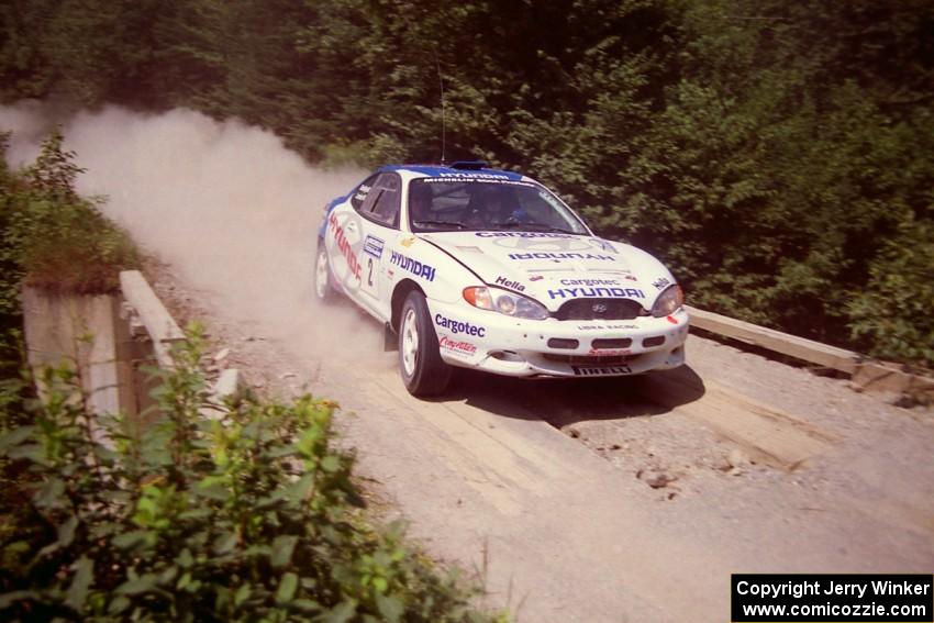 Noel Lawler / Charles Bradley Hyundai Tiburon at speed over a bridge on SS5, Magalloway North.