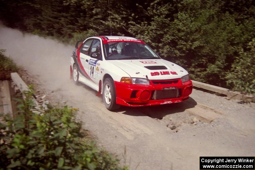 Garen Shrader / Doc Schrader Mitsubishi Lancer Evo IV at speed over a bridge on SS5, Magalloway North.