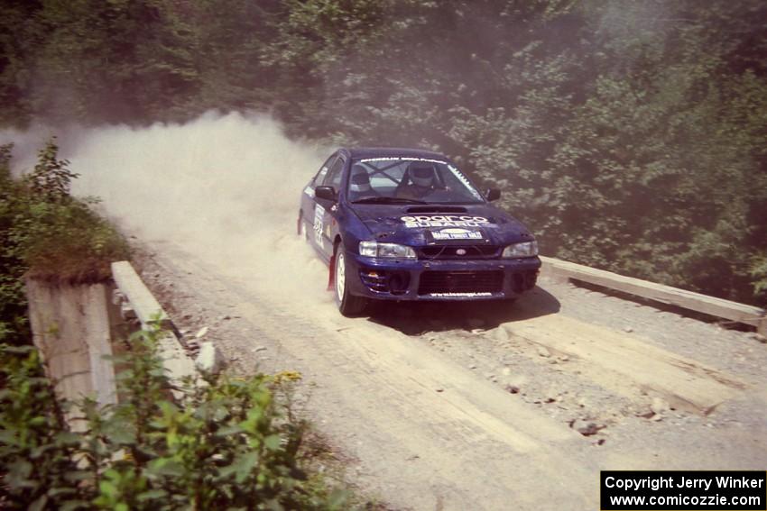 Bill Driegert / Claire Chizma Subaru WRX at speed over a bridge on SS5, Magalloway North.