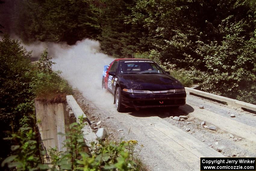 Cal Landau / Eric Marcus Mitsubishi Eclipse GSX at speed over a bridge on SS5, Magalloway North.