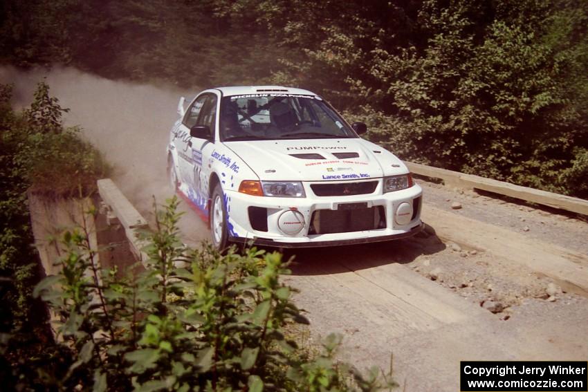 Malachy Crawford / Finian Hannigan Mitsubishi Lancer Evo V at speed over a bridge on SS5, Magalloway North.