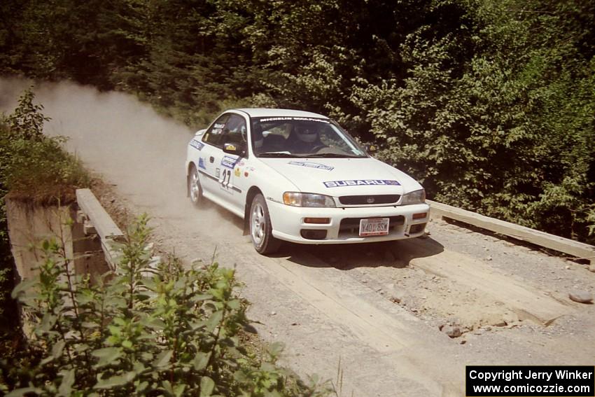 Greg Healey / John MacLeod Subaru Impreza at speed over a bridge on SS5, Magalloway North.