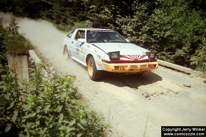 Mark Bowers / Duffy Bowers Mitsubishi Starion at speed over a bridge on SS5, Magalloway North.