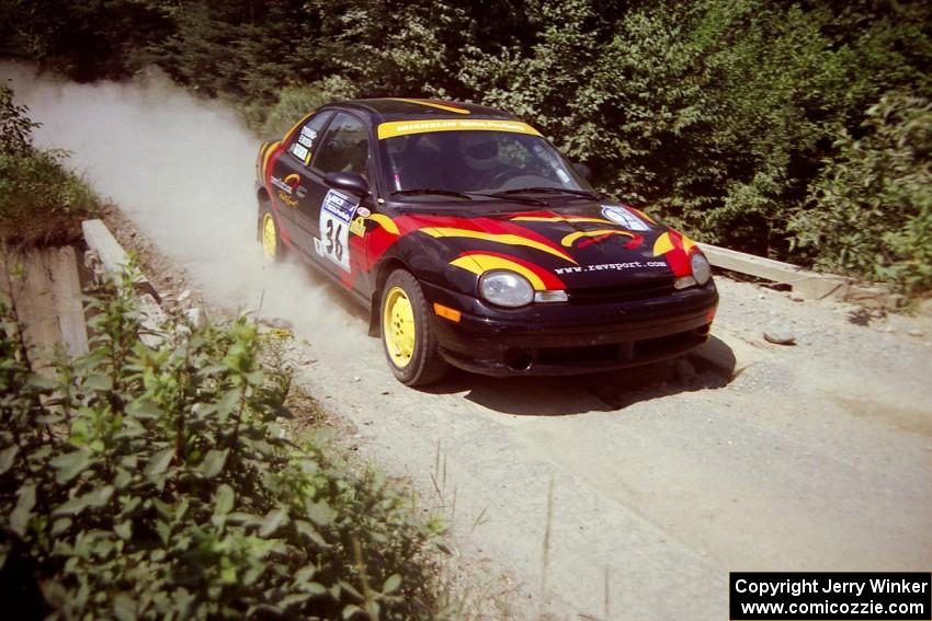 Evan Moen / Tom Young  Plymouth Neon ACR at speed over a bridge on SS5, Magalloway North.