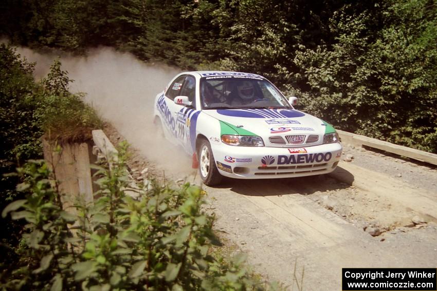 Peter Malaszuk / Darek Szerejko Daewoo Nubira at speed over a bridge on SS5, Magalloway North.