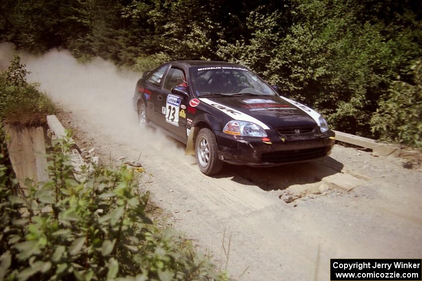 Nick Robinson / Carl Lindquist Honda Civic at speed over a bridge on SS5, Magalloway North.