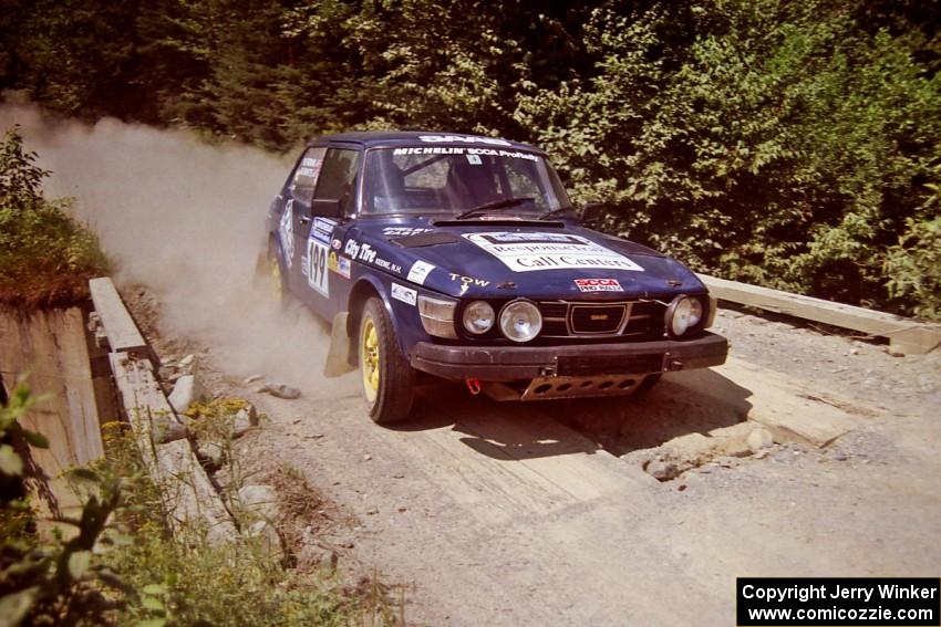 Mike White / Mike Ronan SAAB 99GLI at speed over a bridge on SS5, Magalloway North.