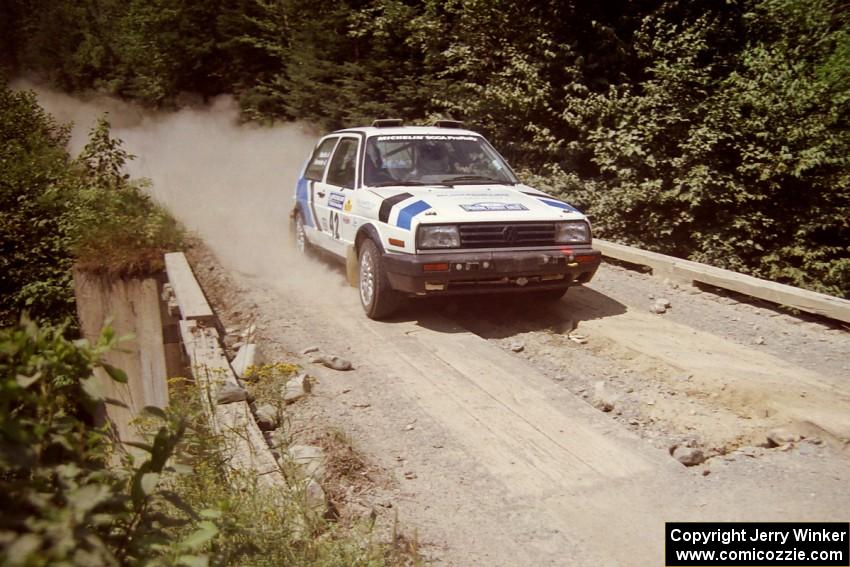 Eric Burmeister / Mark Buskirk VW GTI at speed over a bridge on SS5, Magalloway North.