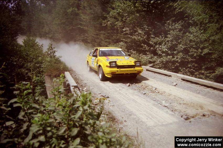 Bruno Laverdiere / Martin Duval Toyota Corolla at speed over a bridge on SS5, Magalloway North.