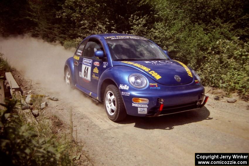 Karl Scheible / Gail McGuire VW Beetle at speed over a bridge on SS5, Magalloway North.